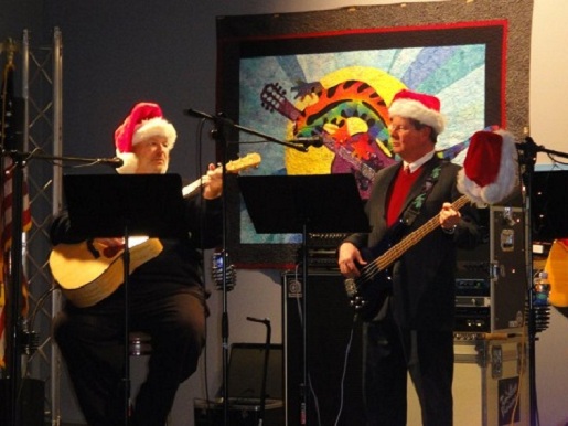 Mark Gardner (right) performs holiday favorites at Santafest.