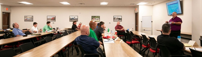 class full of people at a professional driver course 