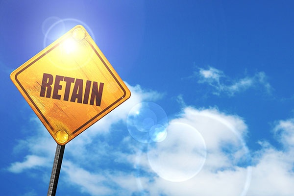 retain: yellow road sign with a blue sky and white clouds