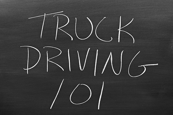 The words "Truck Driving 101" on a blackboard in chalk truck driver training